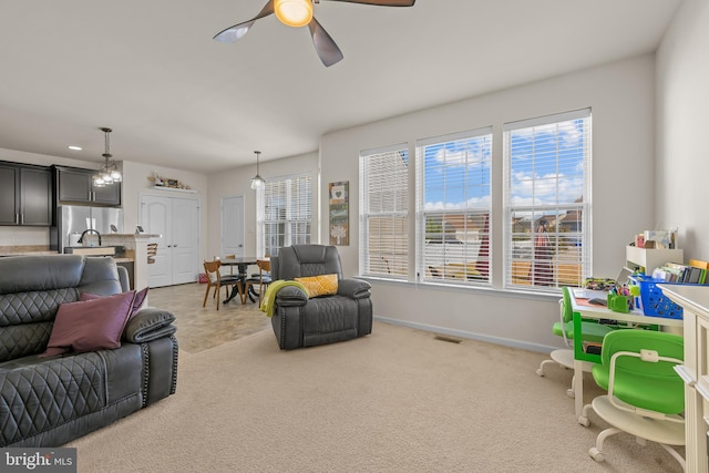 living room featuring ceiling fan and carpet flooring