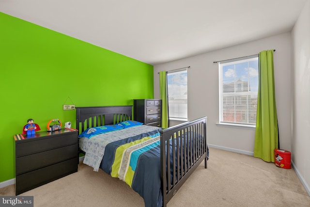 carpeted bedroom featuring multiple windows