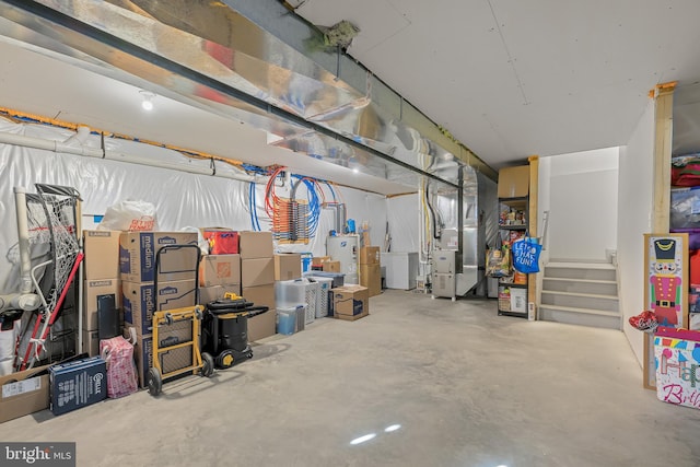 interior space featuring electric water heater and heating unit