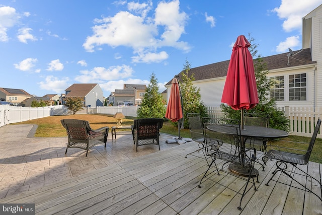 wooden terrace with a lawn