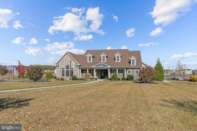 cape cod-style house featuring a front yard