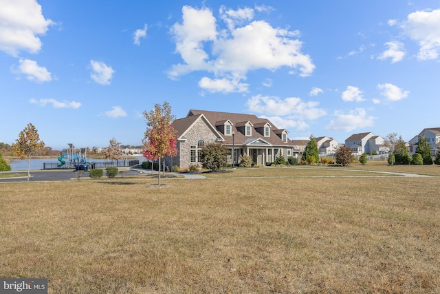 cape cod-style house with a front lawn