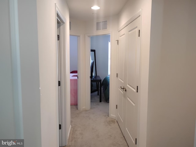 hallway with light colored carpet