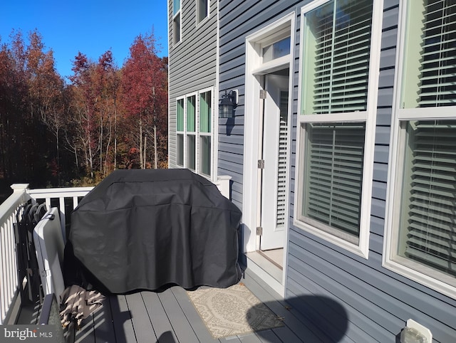 wooden terrace featuring a grill