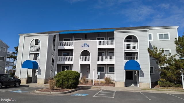 view of building exterior with uncovered parking