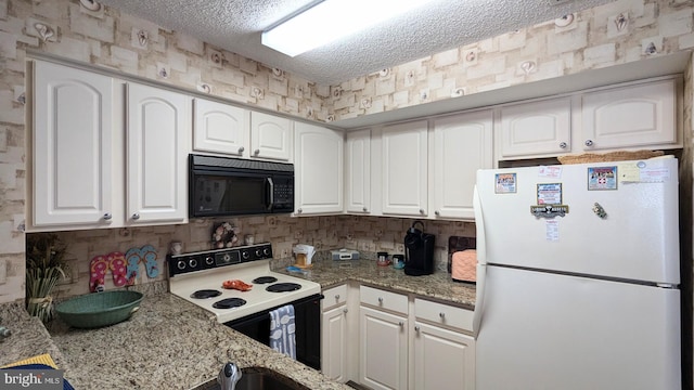 kitchen featuring white cabinets, light stone counters, and white appliances