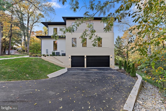 view of property exterior with a yard and a garage