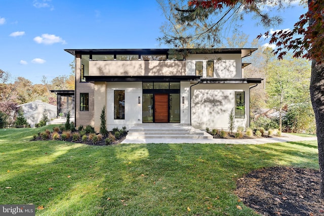 modern home featuring a front lawn