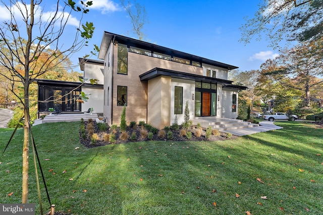 back of property with a patio area and a lawn