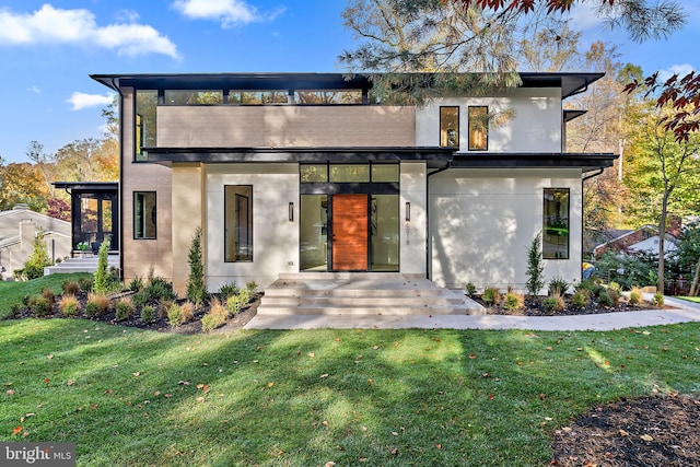 modern home featuring a patio area and a front lawn