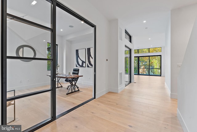 corridor with light hardwood / wood-style flooring