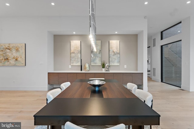 dining space with light hardwood / wood-style floors