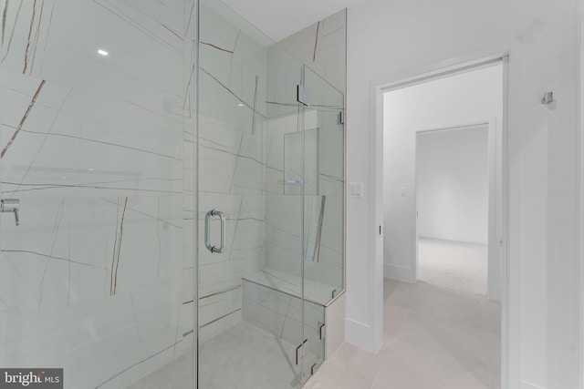 bathroom featuring a shower with shower door