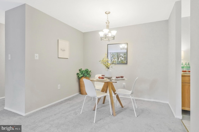 dining space featuring light carpet and a notable chandelier