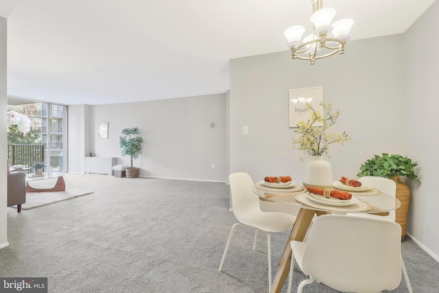 dining space with an inviting chandelier and carpet