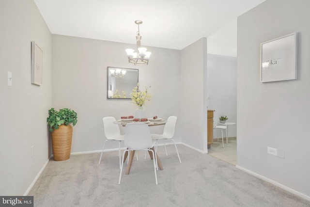 dining area with a notable chandelier and light colored carpet