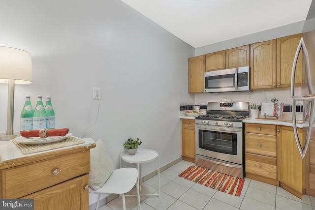 kitchen with stainless steel appliances and light tile patterned floors