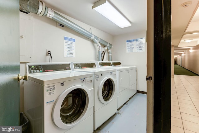 laundry room with light tile patterned flooring and separate washer and dryer