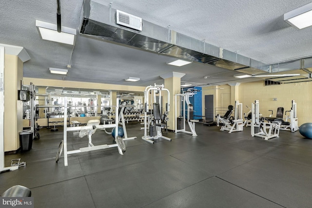 workout area featuring a textured ceiling