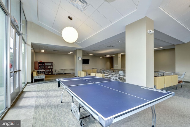 playroom with lofted ceiling and light colored carpet