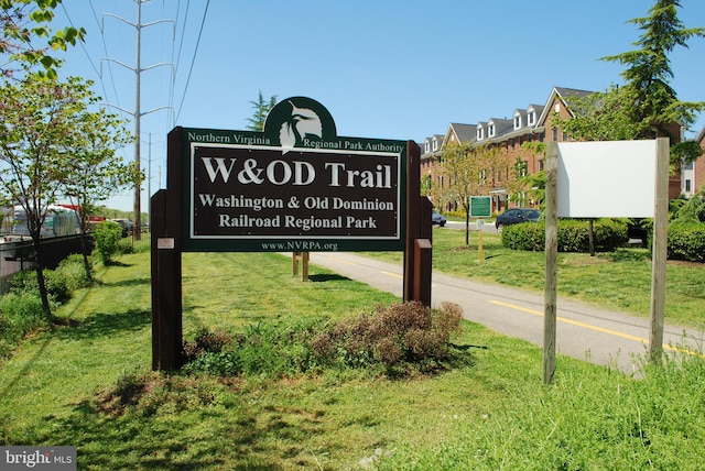 community sign featuring a lawn