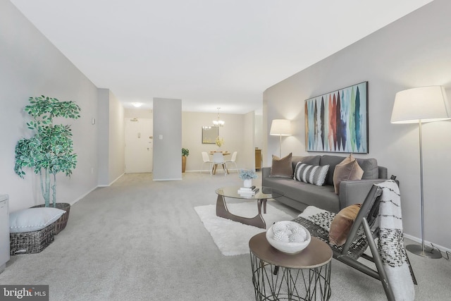 carpeted living room featuring a chandelier