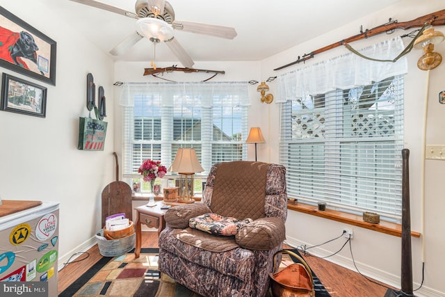 sitting room featuring hardwood / wood-style floors and ceiling fan