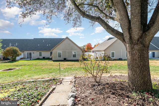 rear view of house with a yard