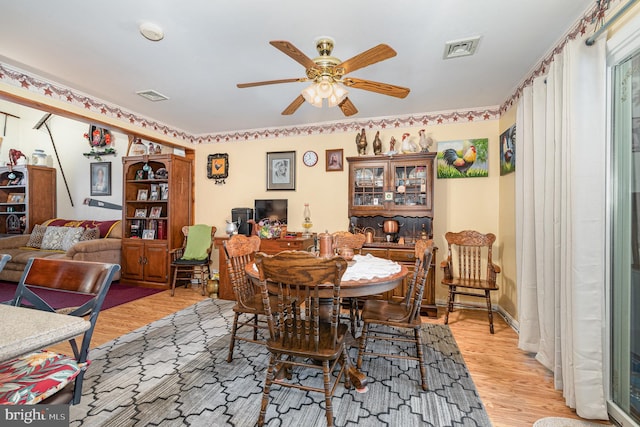 dining space featuring light hardwood / wood-style floors and ceiling fan