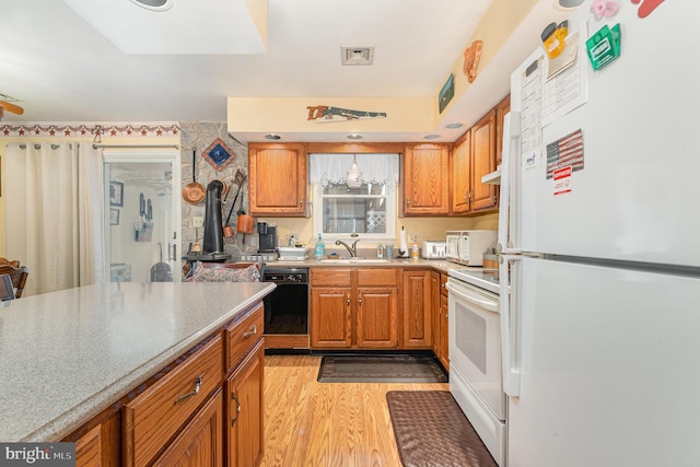 kitchen featuring light hardwood / wood-style floors, sink, and white appliances