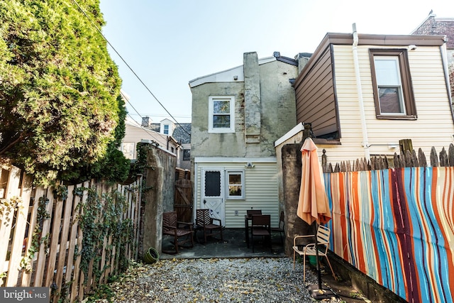 back of property with a patio