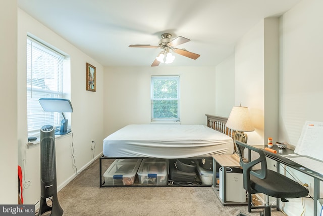 carpeted bedroom with multiple windows and ceiling fan