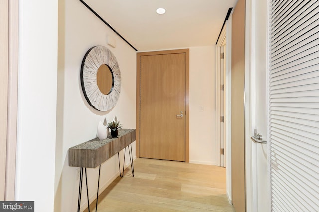 corridor with light wood-type flooring