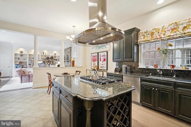 kitchen with island exhaust hood, dark stone counters, stainless steel appliances, sink, and a kitchen island