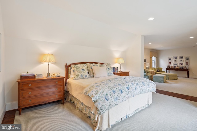 carpeted bedroom with lofted ceiling