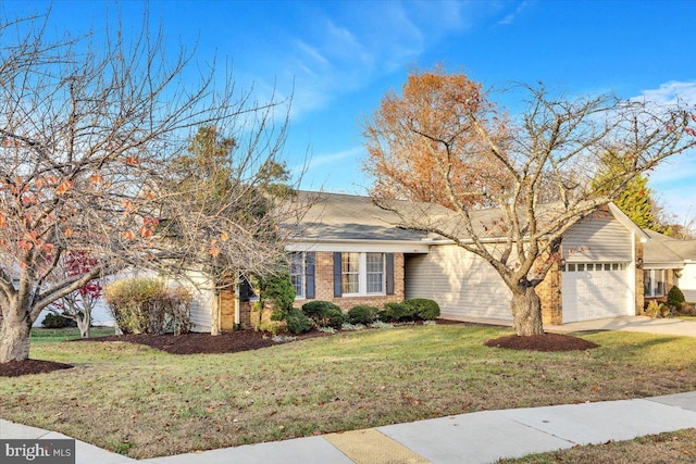 view of front of house with a front yard and a garage