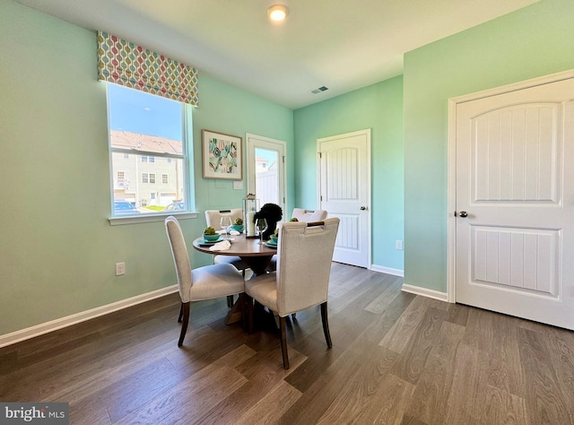 dining room with dark wood-type flooring