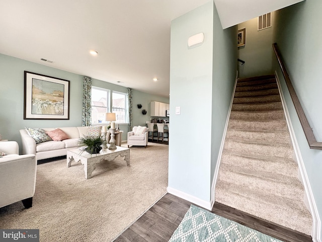 stairs featuring hardwood / wood-style flooring