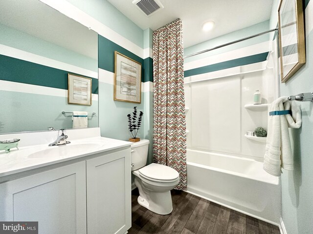 full bathroom with vanity, hardwood / wood-style floors, shower / bath combination with curtain, and toilet