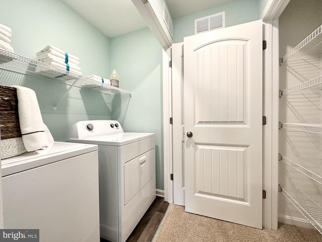 washroom featuring dark carpet and washing machine and clothes dryer