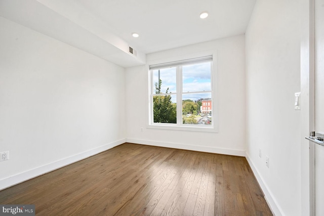 unfurnished room with hardwood / wood-style flooring