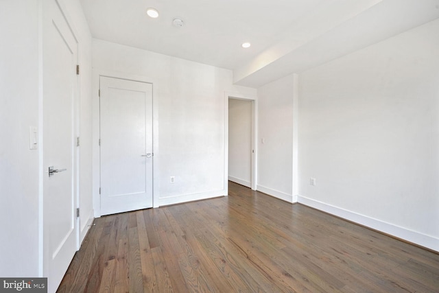 empty room with dark hardwood / wood-style flooring