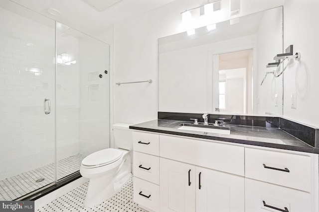 bathroom featuring toilet, vanity, and walk in shower