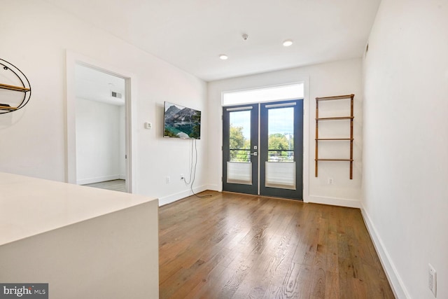 foyer entrance featuring hardwood / wood-style flooring and french doors