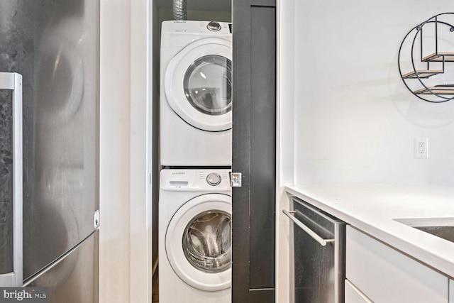 clothes washing area with stacked washer and dryer