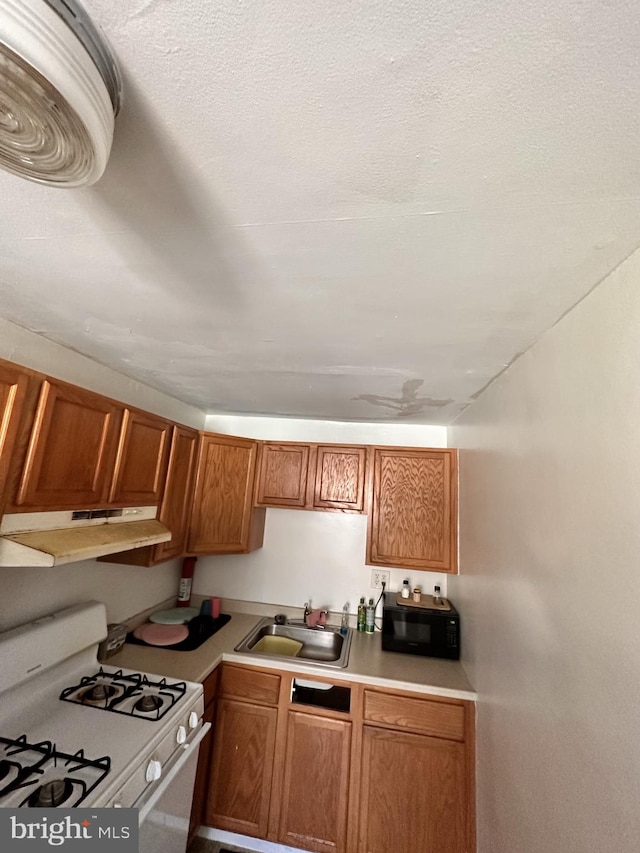 kitchen with sink, white range with gas cooktop, and a textured ceiling