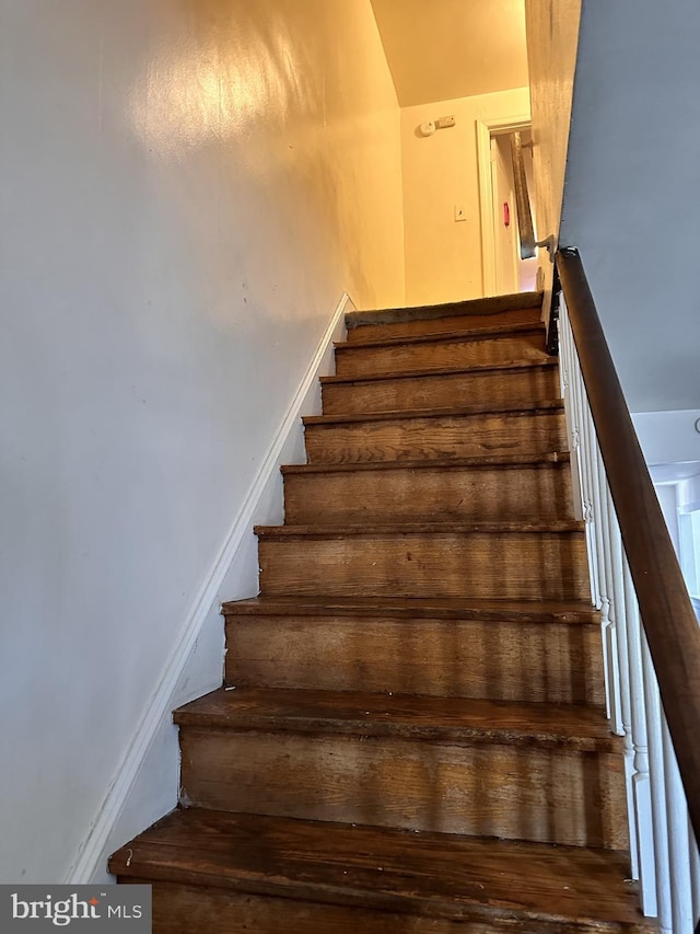 stairs with wood-type flooring