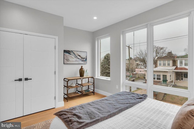 bedroom featuring a closet and light hardwood / wood-style flooring