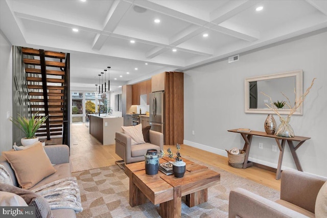 living room with beam ceiling, light hardwood / wood-style floors, and coffered ceiling