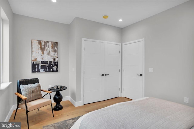 bedroom with light wood-type flooring and a closet